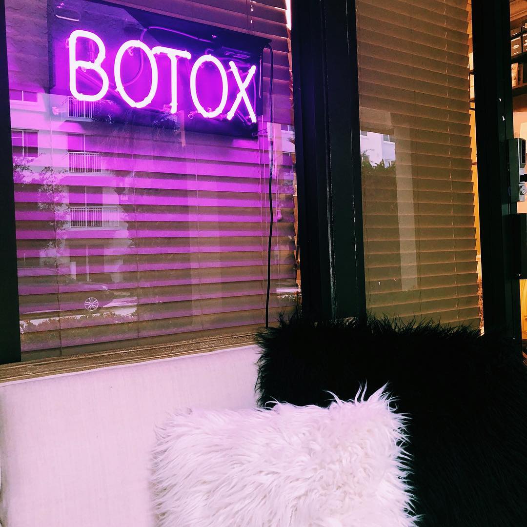 A Botox sign on a room's window Part of a room with a Botox sign on the window